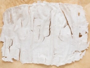 Dried sourdough starter on a wooden cutting board.