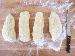 Challah dough cut into four portions.