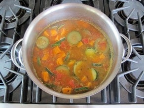 Sliced vegetables in a stockpot.