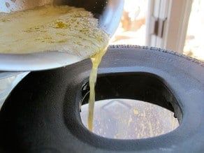 Drizzling egg yolk into running blender.