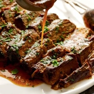 Slow cooker beef tenderloin served with spicy roasted carrots and fennel served on a white plate