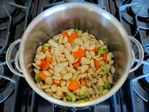 Carrot, celery, and soaked beans added to stockpot.