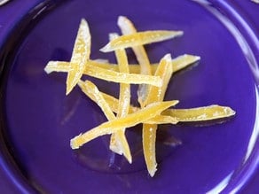 Candied lemon peels on a plate.