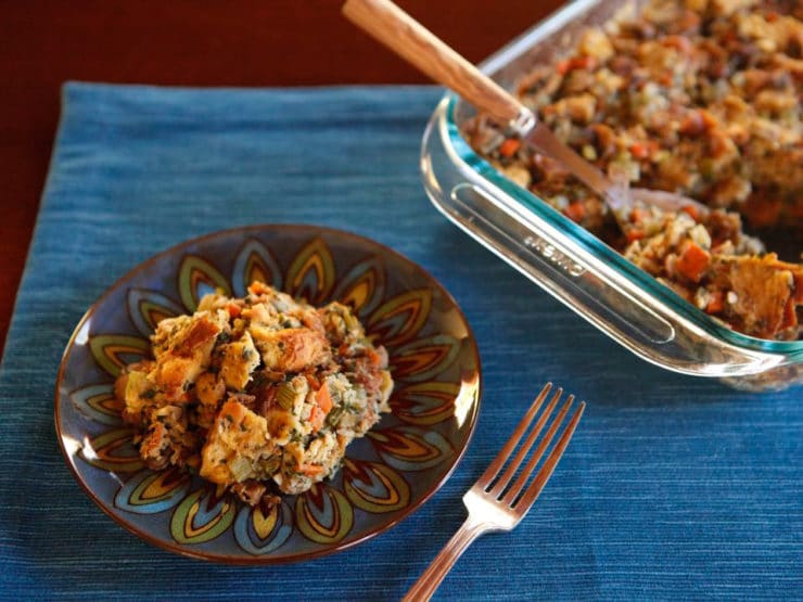 Challah Chestnut Stuffing on a plate with a fork on the side