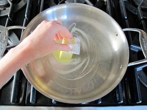 Buttering a skillet.