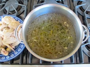 Pulling cooked chicken from bones.