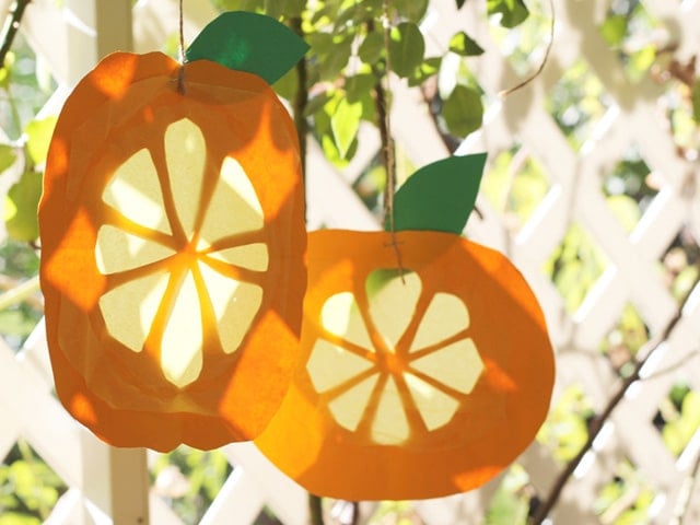 Citron Sun Catchers art craft made of color papers and strings tied to a tree for the Sukkot Jewish Holiday