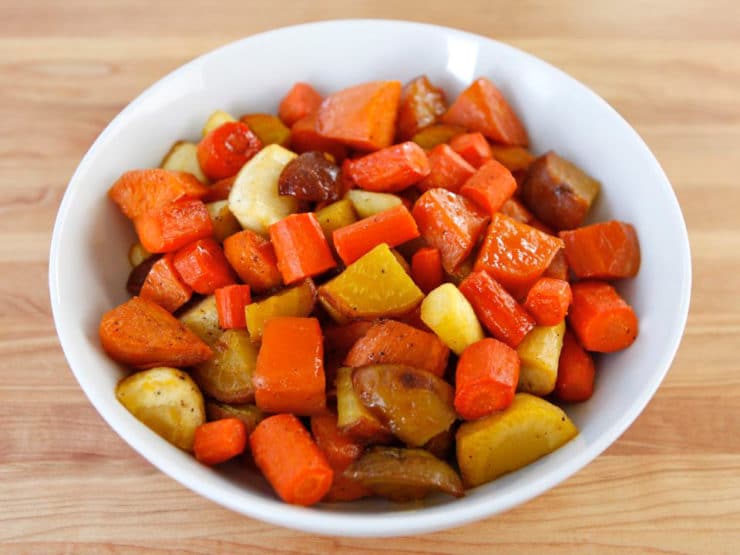 Citrus Honey Glazed mixed vegetables served in a white bowl on top of a wood table