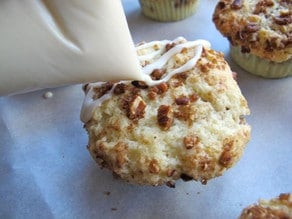 Drizzling frosting over streusel cupcakes.