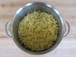 Buttered noodles in a stockpot.