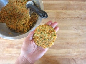 Forming latke mixture into flat circles.