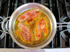 Frying Tilapia in a skillet.