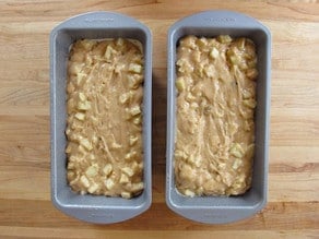 Apple cake batter in two loaf pans.