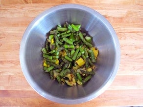 Grilled veggies, diced into a bowl.