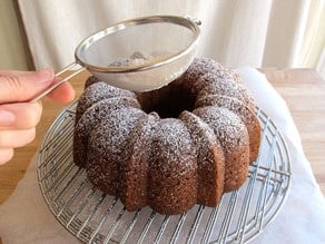 Dusting a bundt cake with powdered sugar.