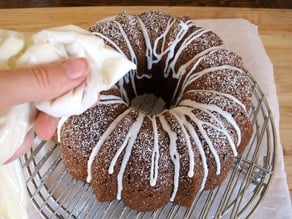 Drizzling icing over a bundt cake.