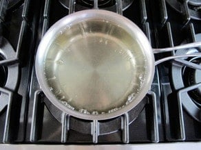 Making simple syrup in a saucepan.