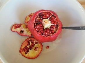 Cut slits in sides of pomegranate.