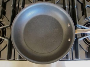 Nonstick skillet preheating on stovetop.