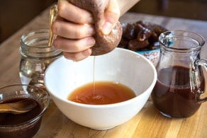 Squeezing water from dates through cheesecloth.