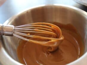 Tahini glaze being whisked in a small mixing bowl.