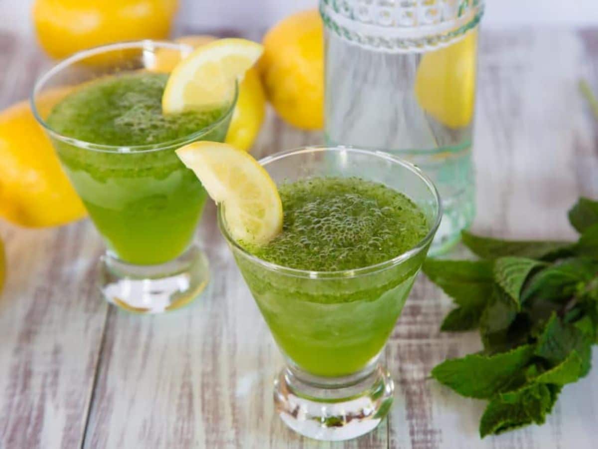 Two glasses of spiked Limonana, a green drink with lemons, mint, and a hint of vodka