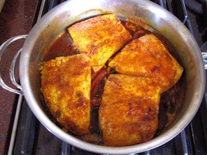 Fish fillets in a large saute pan.