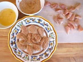 Breaded chicken bites on a plate.