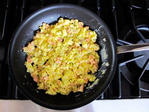 Scrambled eggs in a skillet.