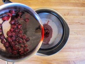 Straining blackberries on a strainer straight to a huge bowl