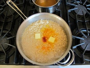 Saffron and butter added to risotto.