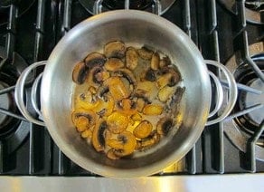 Mushrooms and onions sauteeing.