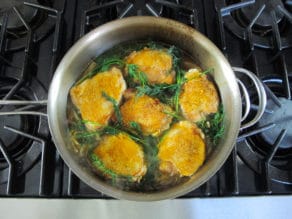 Fresh basil added to chicken thighs.