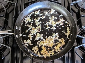 Sardines and capers in a saute pan.