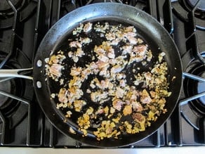 Sardines and capers in a saute pan.