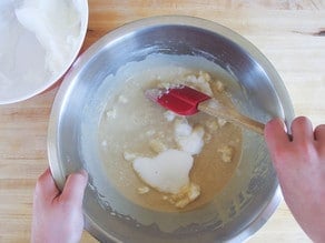 Folding egg whites into waffle batter.