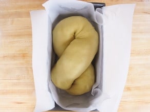 Babka dough shaped and placed in a loaf pan.