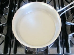 Making orange blossom syrup on stove.