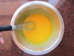 Egg yolks and sugar in a bowl.