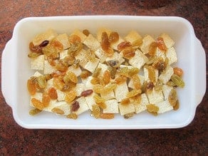 Cubed bread in a baking dish.