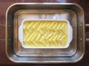 Bread pudding baking in a water bath.