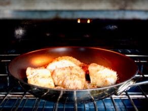 4 Teriyaki Black Cod fillers in skillet under hot broiler in oven.