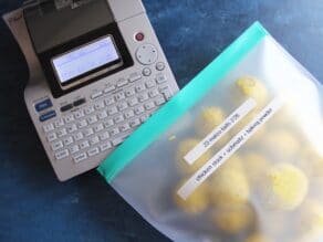 label maker with silicone freezer bag full of matzo balls, labeled and ready for freezing.