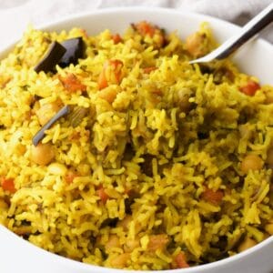 Horizontal Shot - close up of Middle Eastern Roasted Vegetable Rice in a bowl with a spoon.