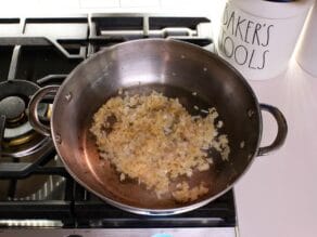 Onions softened and golden in pan on stovetop.