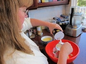 Sifting flour into a mixing bowl.