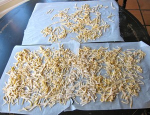 Cut noodles drying on parchment.