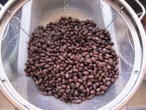 Black beans in a strainer by the sink