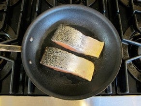 Searing salmon, flesh side down.