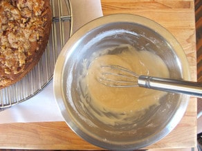 Whisking glaze ingredients in a mixing bowl.